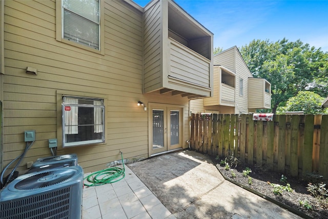 back of property featuring french doors, a patio, and central AC unit