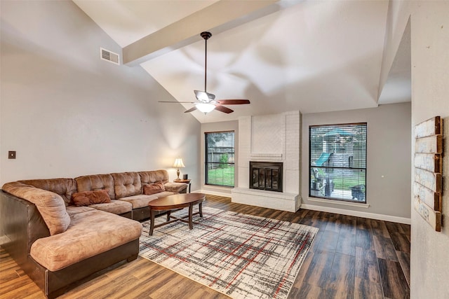 living room featuring hardwood / wood-style flooring, ceiling fan, a healthy amount of sunlight, and a fireplace