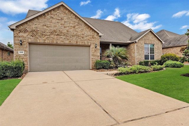 view of front of house featuring a front yard and a garage