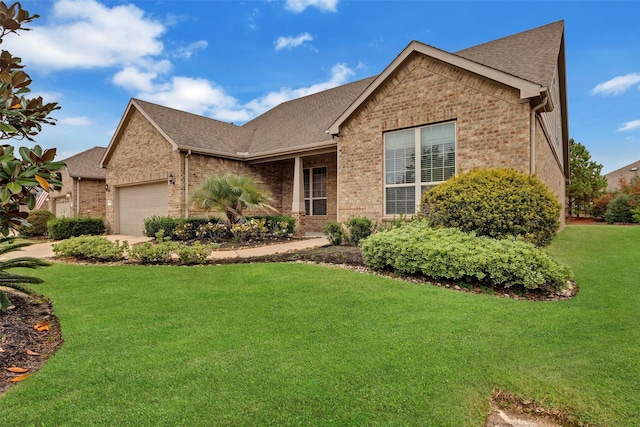 view of front of property with a front yard and a garage