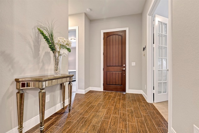 foyer entrance featuring dark wood-type flooring