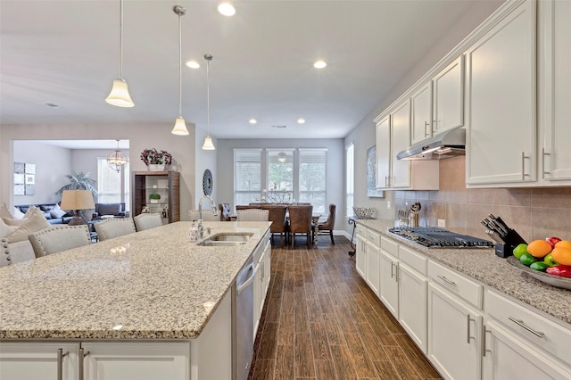 kitchen featuring appliances with stainless steel finishes, dark hardwood / wood-style flooring, a kitchen island with sink, sink, and white cabinets