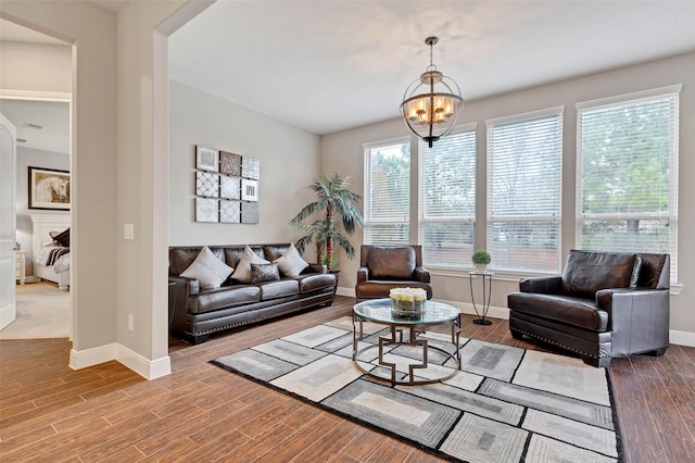 living room with a chandelier and wood-type flooring