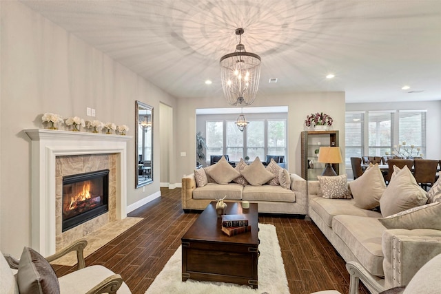 living room with a healthy amount of sunlight, a fireplace, and dark wood-type flooring