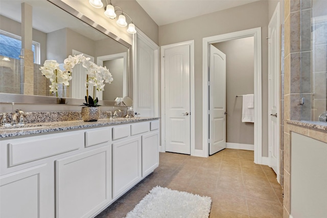 bathroom featuring tile patterned flooring, vanity, and walk in shower