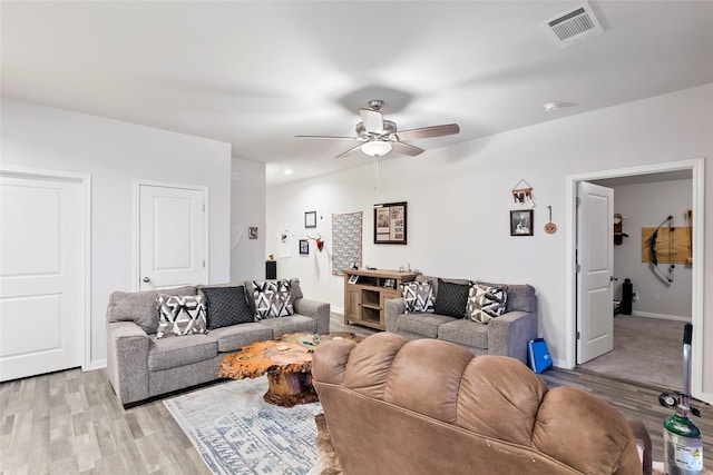 living room with ceiling fan and light wood-type flooring