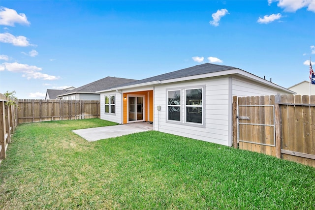 back of house featuring a patio area and a lawn