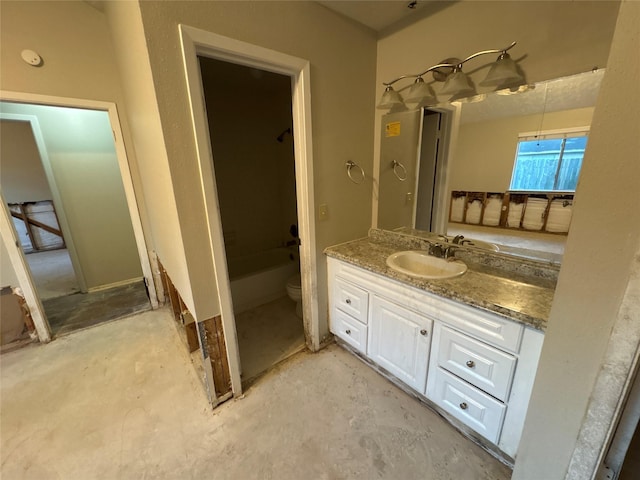 bathroom featuring vanity, concrete floors, and toilet