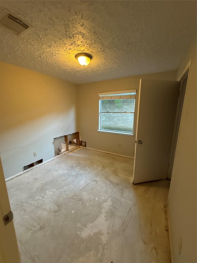 empty room with a textured ceiling