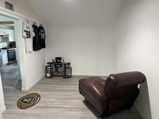 sitting room with lofted ceiling and light hardwood / wood-style flooring