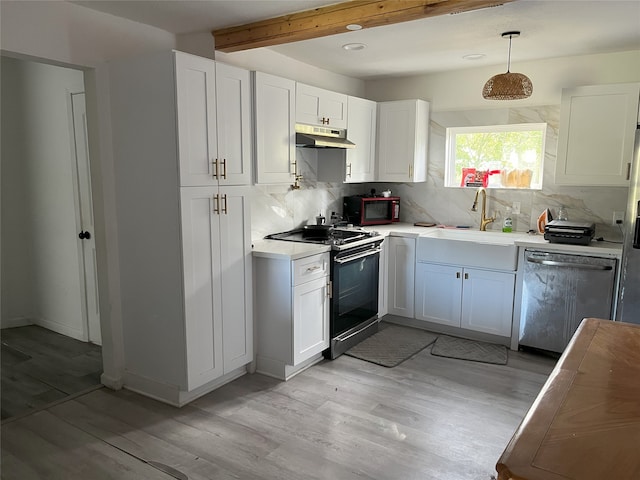 kitchen featuring black range oven, hanging light fixtures, white cabinetry, and stainless steel dishwasher