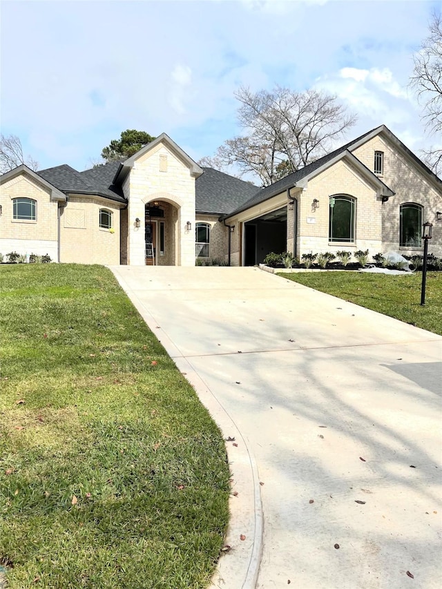 view of front of house with a garage and a front lawn