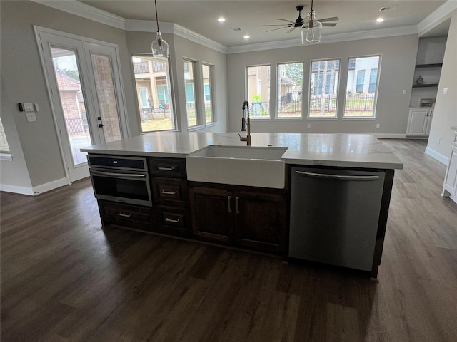 kitchen with hardwood / wood-style flooring, sink, a kitchen island with sink, and appliances with stainless steel finishes