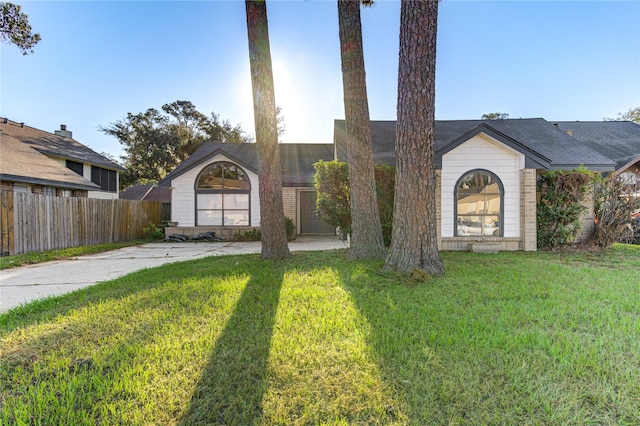 ranch-style home with a front lawn