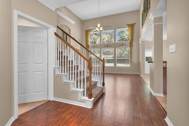 foyer with a high ceiling, hardwood / wood-style flooring, and ceiling fan