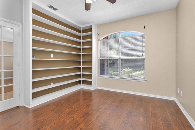 spare room with dark hardwood / wood-style flooring and ceiling fan