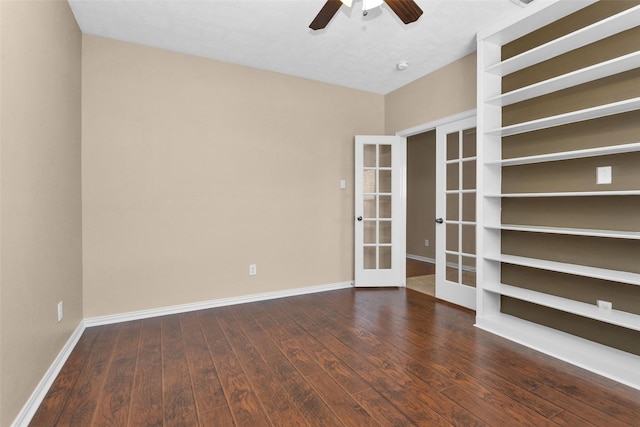 empty room featuring ceiling fan, dark hardwood / wood-style flooring, and french doors