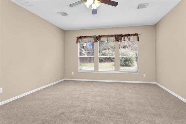 empty room with ceiling fan and carpet floors