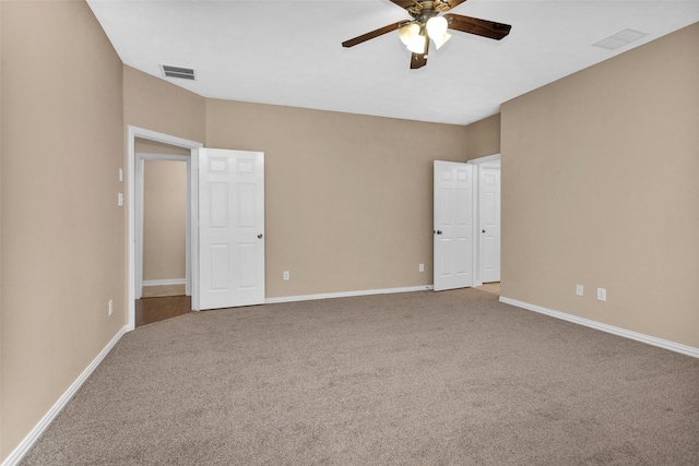 spare room featuring carpet and ceiling fan