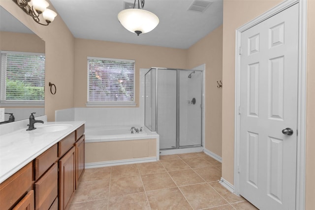 bathroom with tile patterned floors, vanity, and independent shower and bath