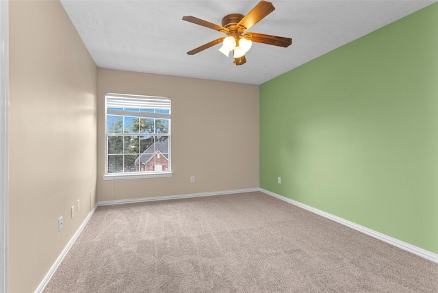 spare room with ceiling fan and light colored carpet