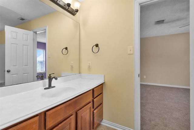 bathroom with vanity and a textured ceiling