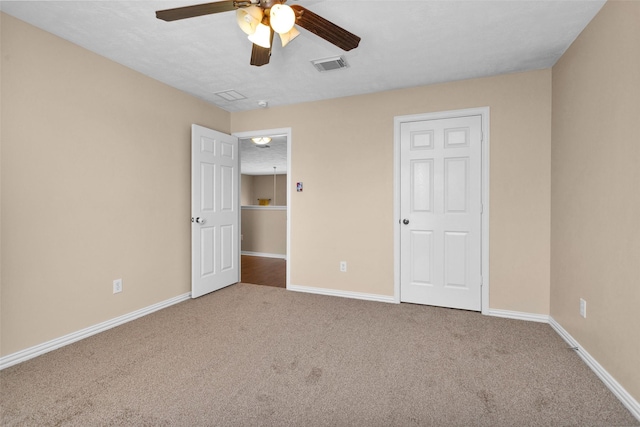 unfurnished bedroom featuring ceiling fan, carpet, and a textured ceiling