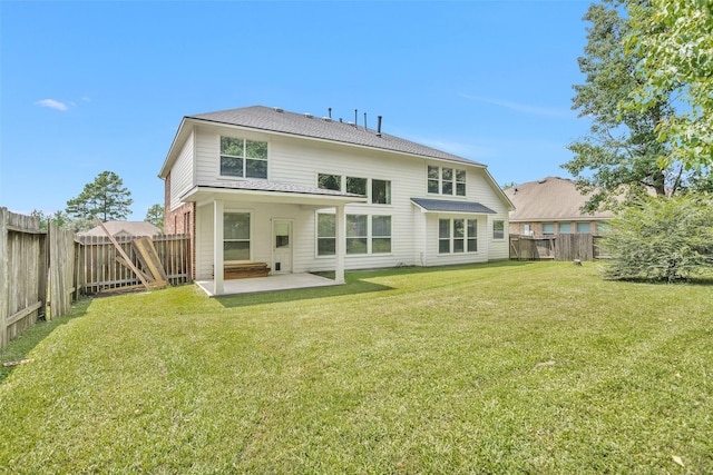 rear view of property featuring a patio and a lawn