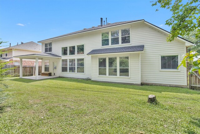 back of property featuring a lawn and a patio area