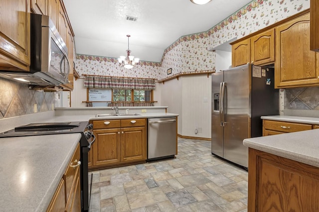 kitchen featuring sink, hanging light fixtures, stainless steel appliances, tasteful backsplash, and a notable chandelier