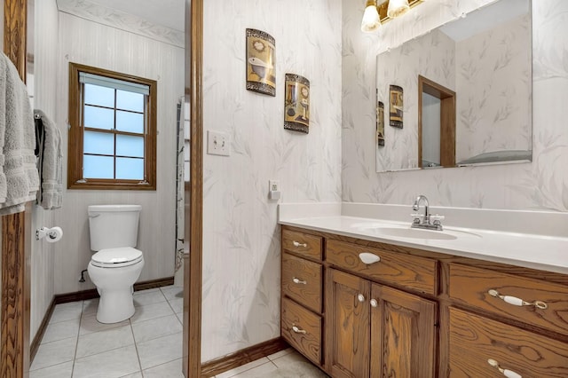 bathroom with tile patterned flooring, vanity, and toilet