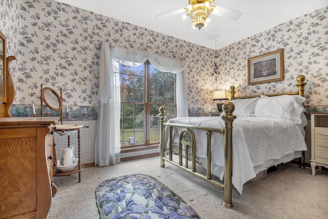 carpeted bedroom with ceiling fan and multiple windows