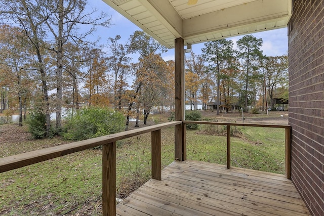 wooden deck with a lawn