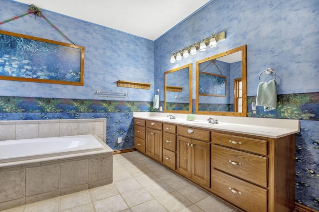 bathroom featuring tile patterned floors, tiled tub, and vanity