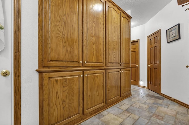 corridor featuring a textured ceiling