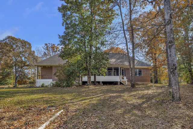 view of front of house featuring a front lawn and a sunroom