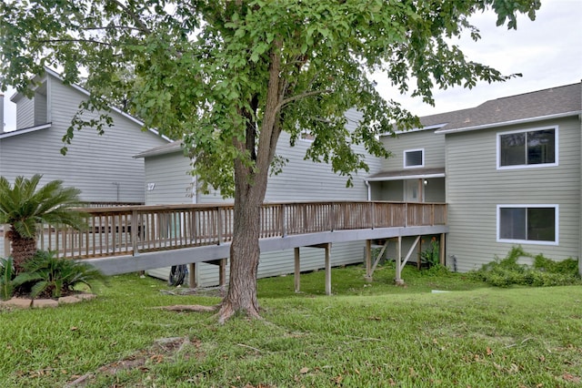 back of property with a lawn and a deck