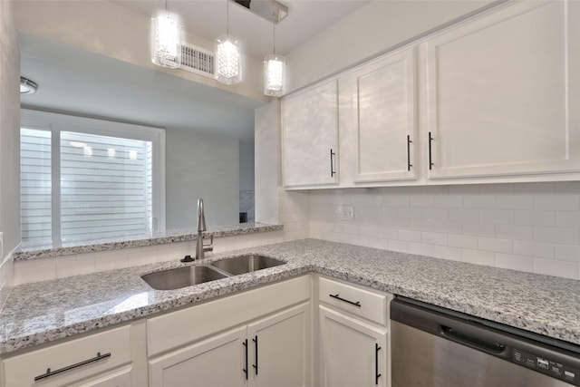 kitchen with white cabinetry, dishwasher, light stone countertops, and sink