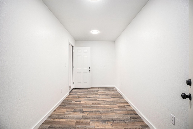 corridor with dark hardwood / wood-style flooring