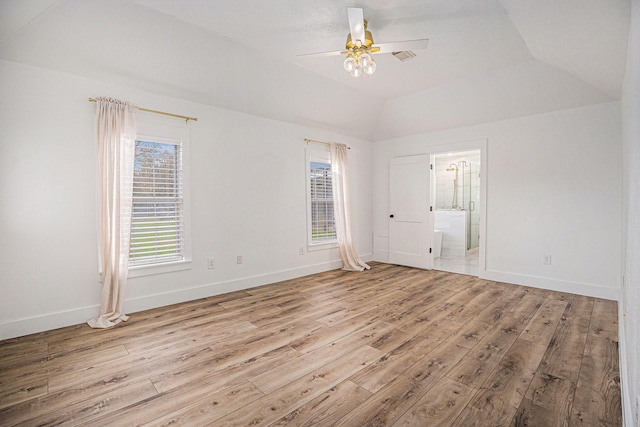 unfurnished room featuring light hardwood / wood-style floors, vaulted ceiling, and ceiling fan