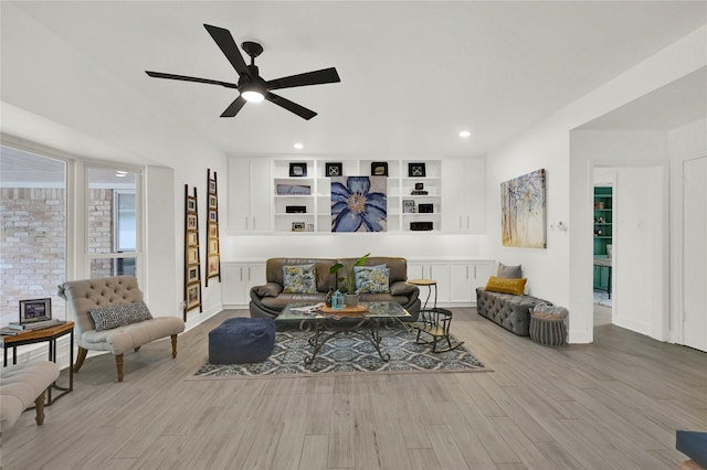 living room featuring ceiling fan and light wood-type flooring