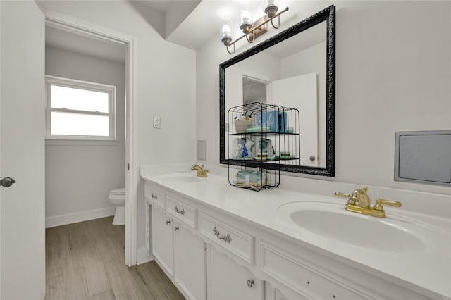 bathroom featuring hardwood / wood-style flooring, vanity, and toilet