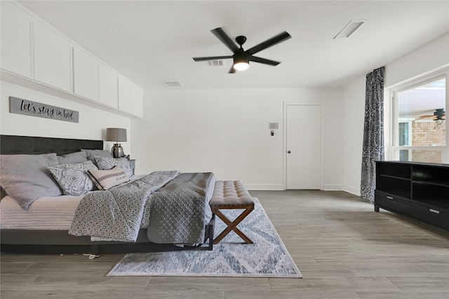 bedroom with ceiling fan and light wood-type flooring