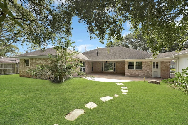 rear view of house with a patio area and a yard