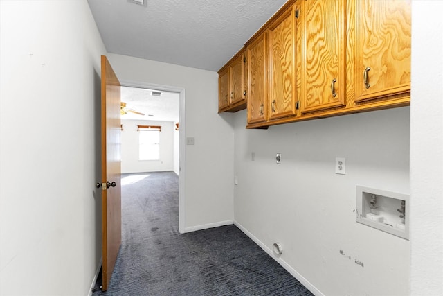 washroom with cabinets, dark colored carpet, washer hookup, a textured ceiling, and hookup for an electric dryer