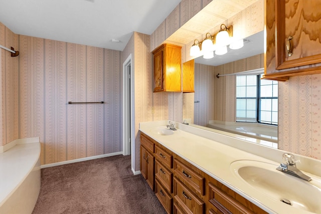 bathroom with vanity and a tub