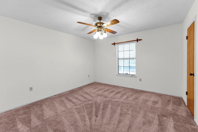 carpeted spare room with a textured ceiling and ceiling fan