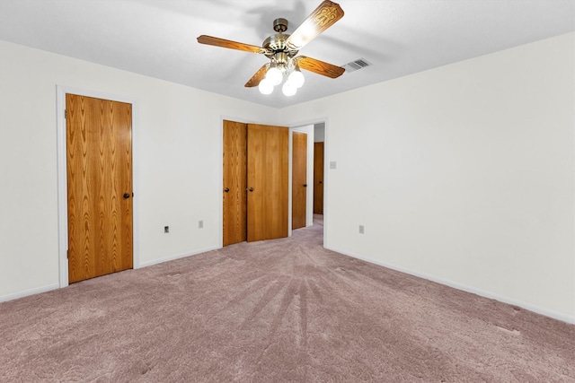 unfurnished bedroom featuring ceiling fan and carpet flooring