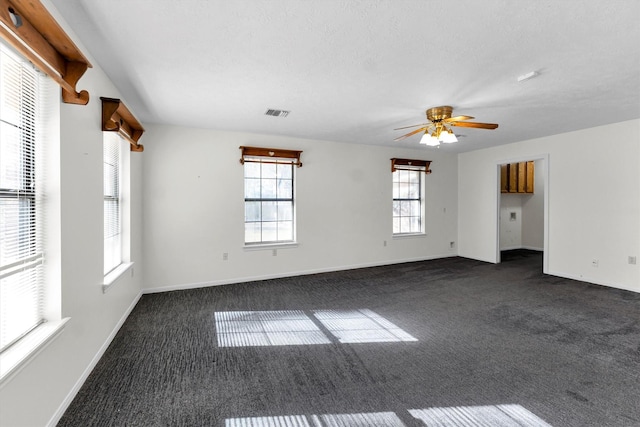 carpeted empty room with a textured ceiling and ceiling fan