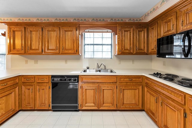 kitchen with sink, light tile patterned floors, and black appliances